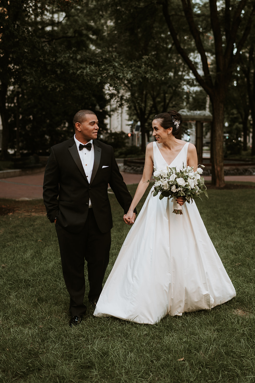 bride and groom walk outside of wedding venue