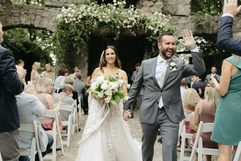 bride and groom walk down the aisle