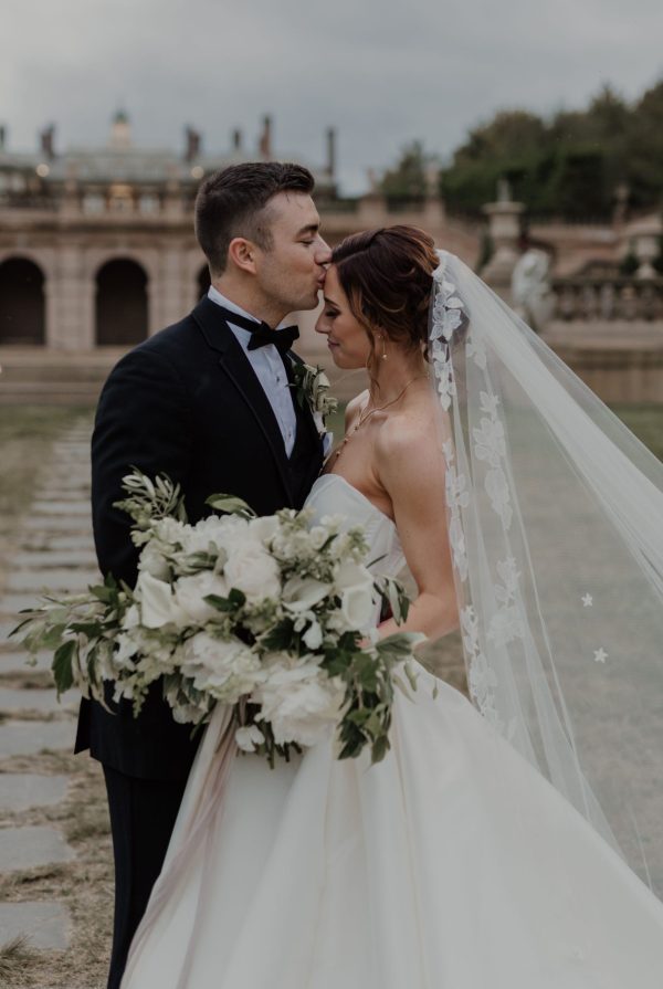 beautiful bridal bouquet being held by bride and groom at outdoor wedding venue