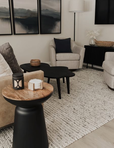 beautiful living room renovation with neutral furniture with black home decor accents and calming art